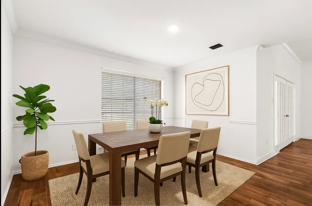 a view of a dining room with furniture and a potted plant