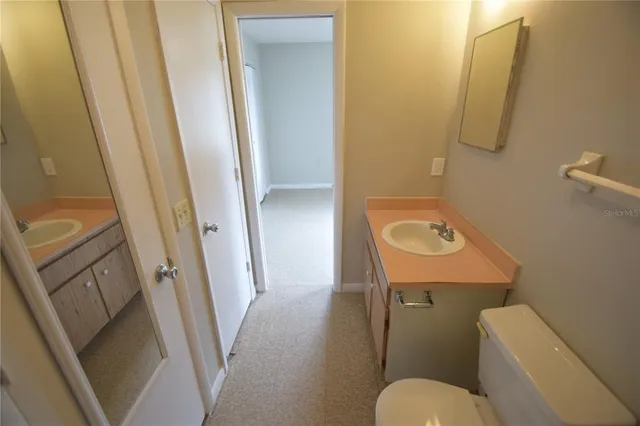 a bathroom with a sink a toilet and a mirror