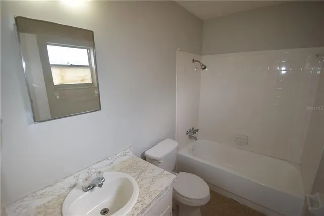 a bathroom with a toilet sink and bathtub
