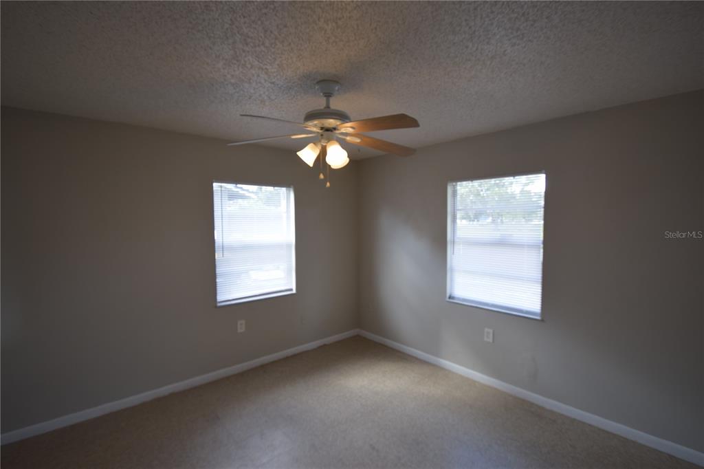 115 Leelon Road, Unit 115 Lakeland, FL 33809 - Photo 5 of 14 an empty room with windows and fan