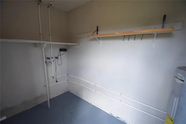 a view of walk in closet with empty racks