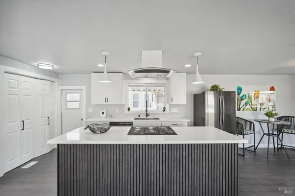 a kitchen with stainless steel appliances a sink stove and refrigerator