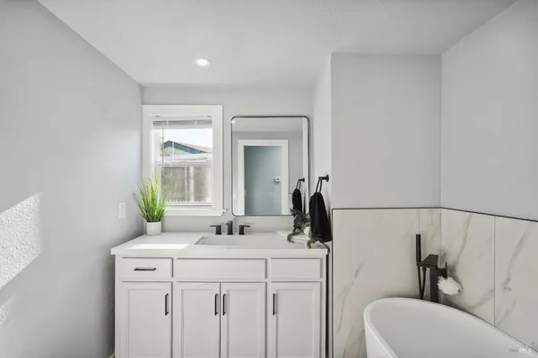 a bathroom with a bathtub and sink