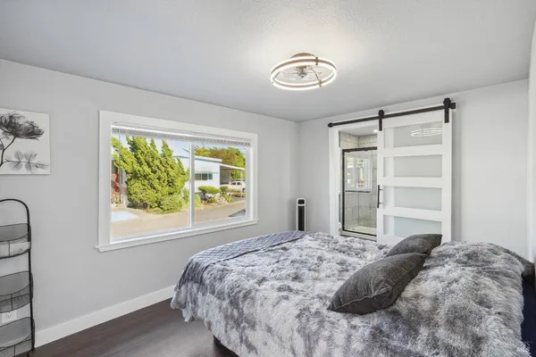 a bedroom with a bed and a chandelier