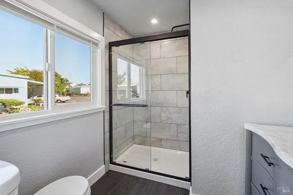a bathroom with a sink vanity and a mirror