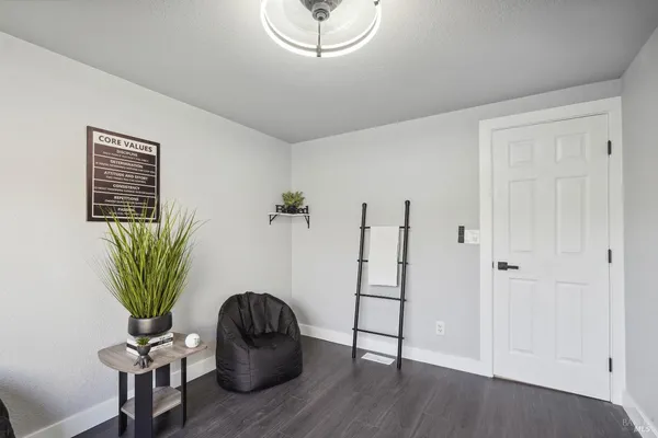 a view of a room with wooden floor