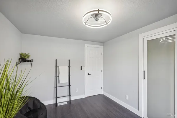 an empty room with wooden floor and a window