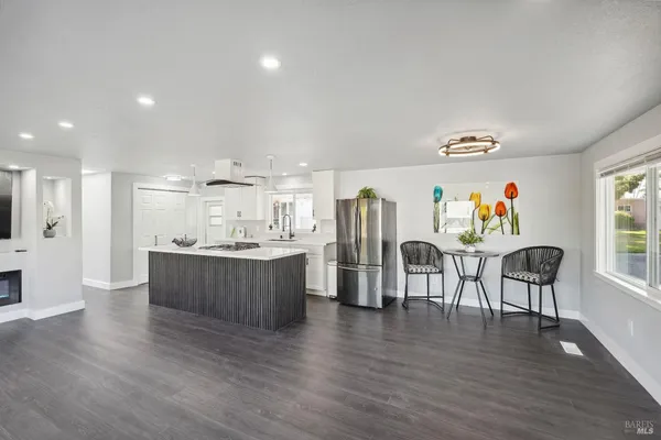a kitchen with stainless steel appliances granite countertop a refrigerator and a stove top oven