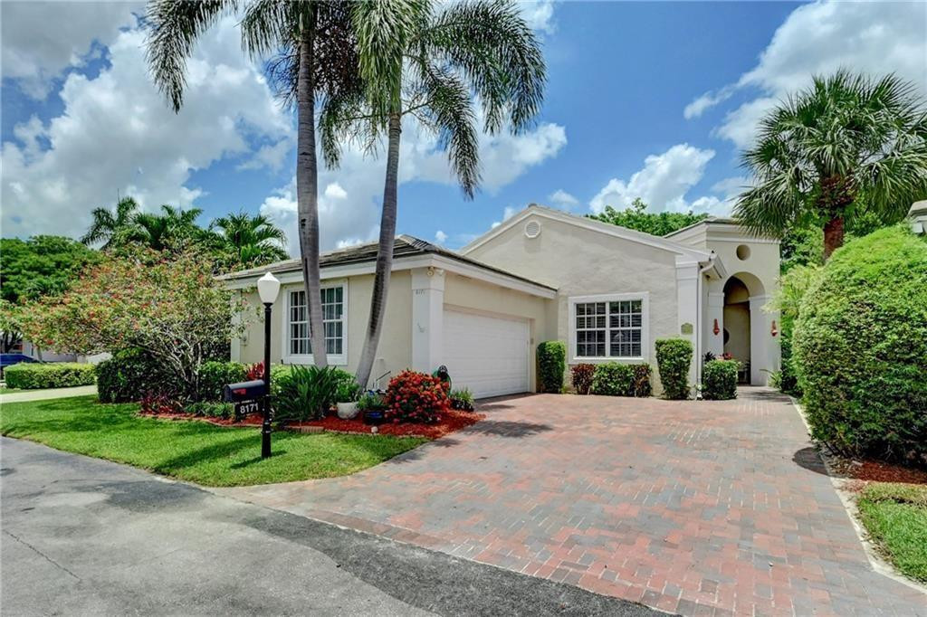 8171 Hampton Wood Drive Boca Raton, FL 33433 - Photo 2 of 56 front view of a house with a garden