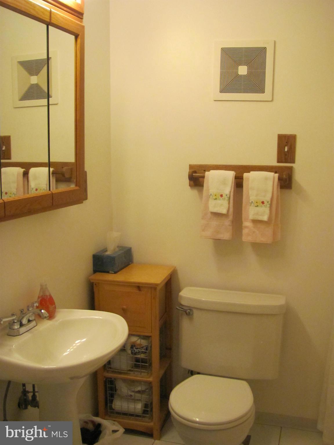 7919 Hillendale Road Baltimore, MD 21234 - Photo 15 of 29 a white toilet sitting next to a bathroom sink