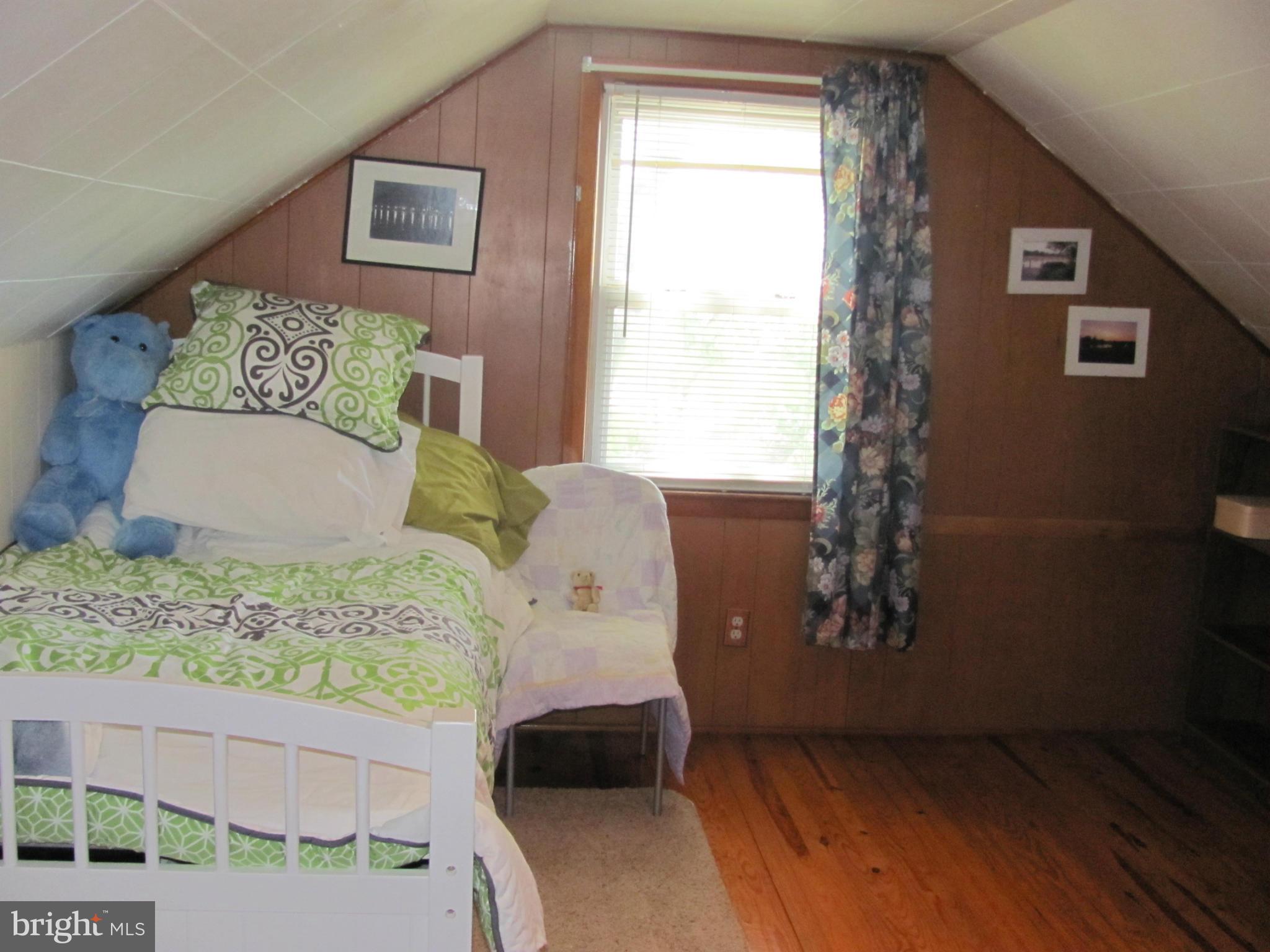 7919 Hillendale Road Baltimore, MD 21234 - Photo 16 of 29 a bed sitting in a bedroom next to a window