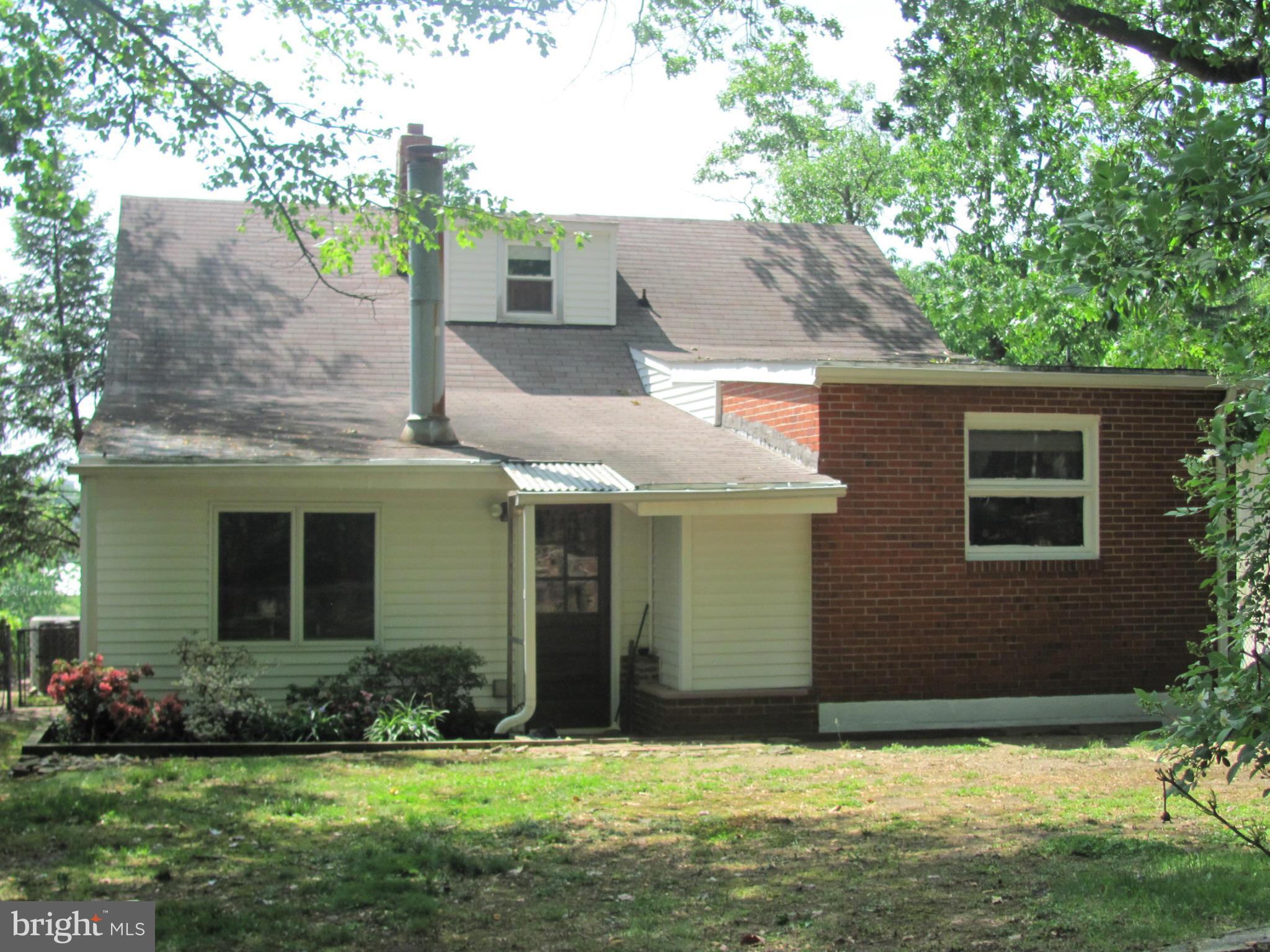 7919 Hillendale Road Baltimore, MD 21234 - Photo 3 of 29 a front view of a house with a yard and garage