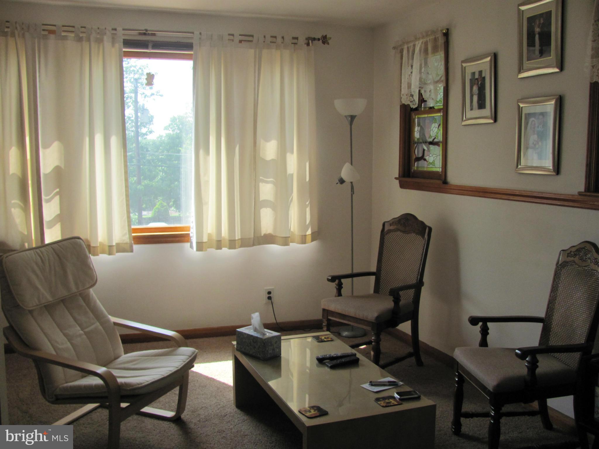 7919 Hillendale Road Baltimore, MD 21234 - Photo 4 of 29 a view of a workspace with furniture and a window