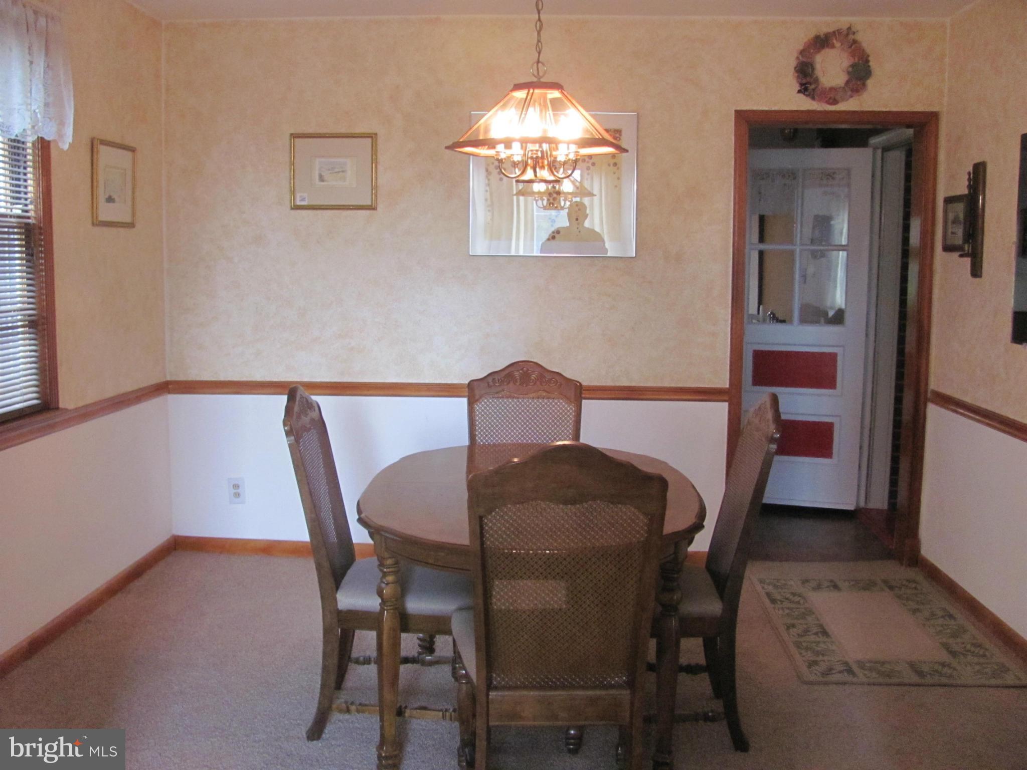 7919 Hillendale Road Baltimore, MD 21234 - Photo 6 of 29 a view of a dining room with furniture and chandelier