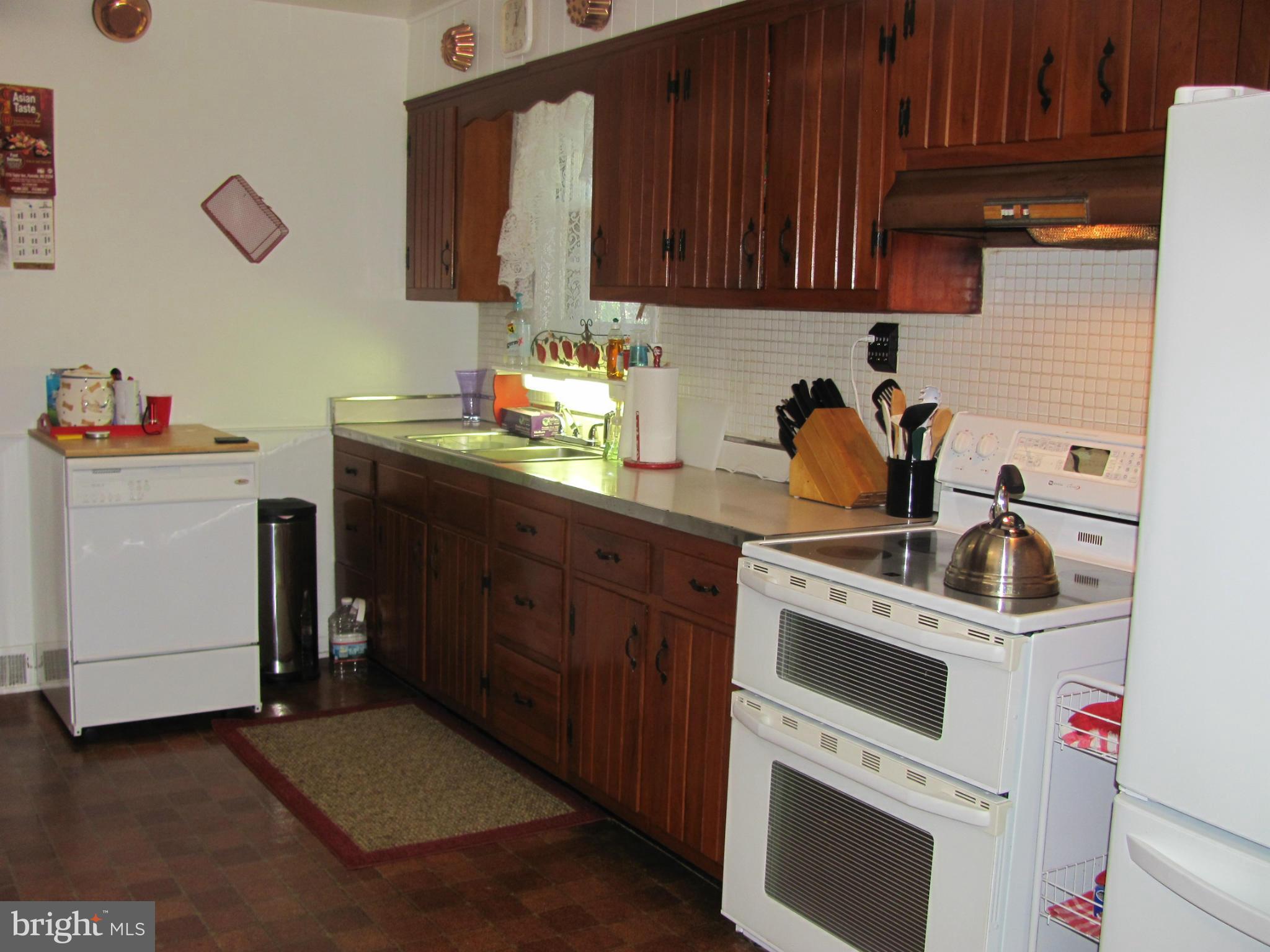 7919 Hillendale Road Baltimore, MD 21234 - Photo 8 of 29 a kitchen with a stove and a sink