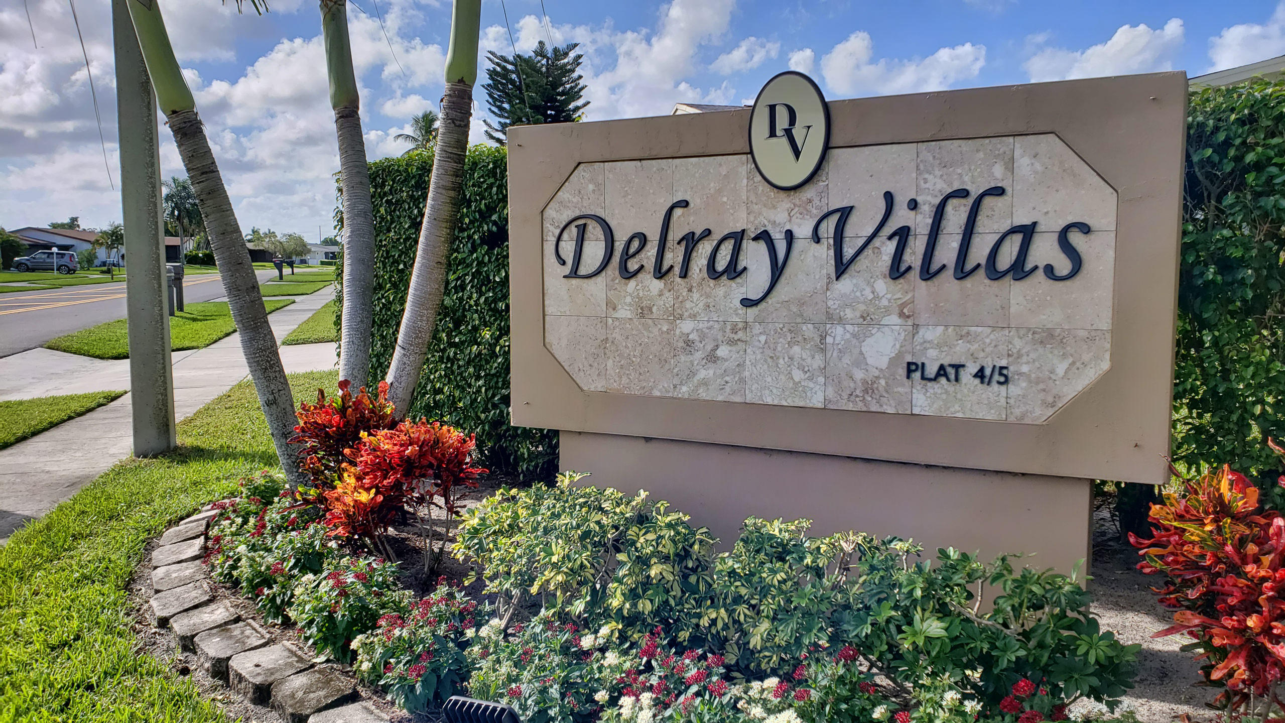 6295 Dusenburg Road Delray Beach, FL 33484 - Photo 2 of 34 a sign on the side of the road