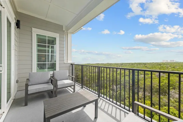 a view of a balcony with furniture