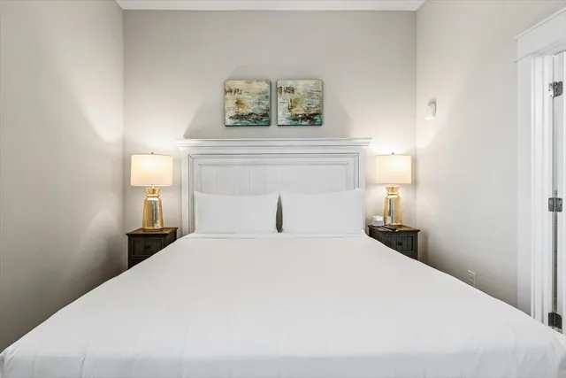 a bedroom with a bed and a night stand