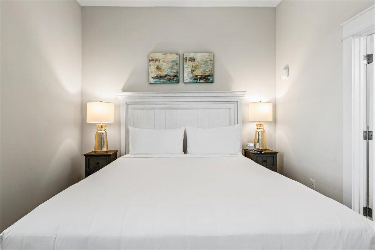 206 Henderson Resort Way, Unit 5403 Destin, FL 32541 - Photo 18 of 41 a bedroom with a bed and a night stand