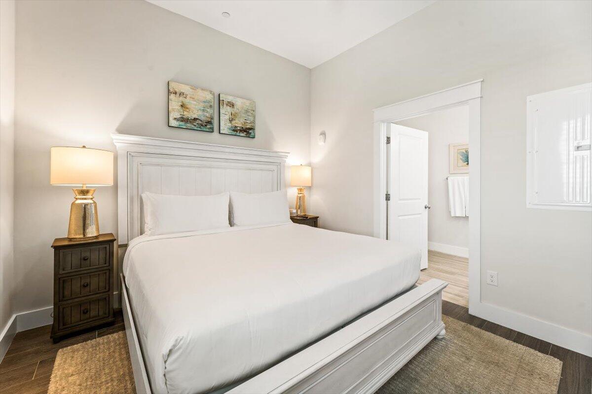 206 Henderson Resort Way, Unit 5403 Destin, FL 32541 - Photo 19 of 41 a bedroom with a bed and a night stand