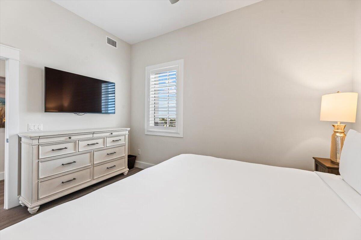 206 Henderson Resort Way, Unit 5403 Destin, FL 32541 - Photo 21 of 41 a bedroom with a bed and a flat screen tv