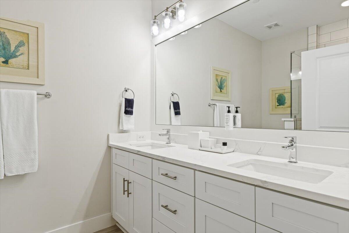 206 Henderson Resort Way, Unit 5403 Destin, FL 32541 - Photo 22 of 41 a bathroom with a double vanity sink and a mirror
