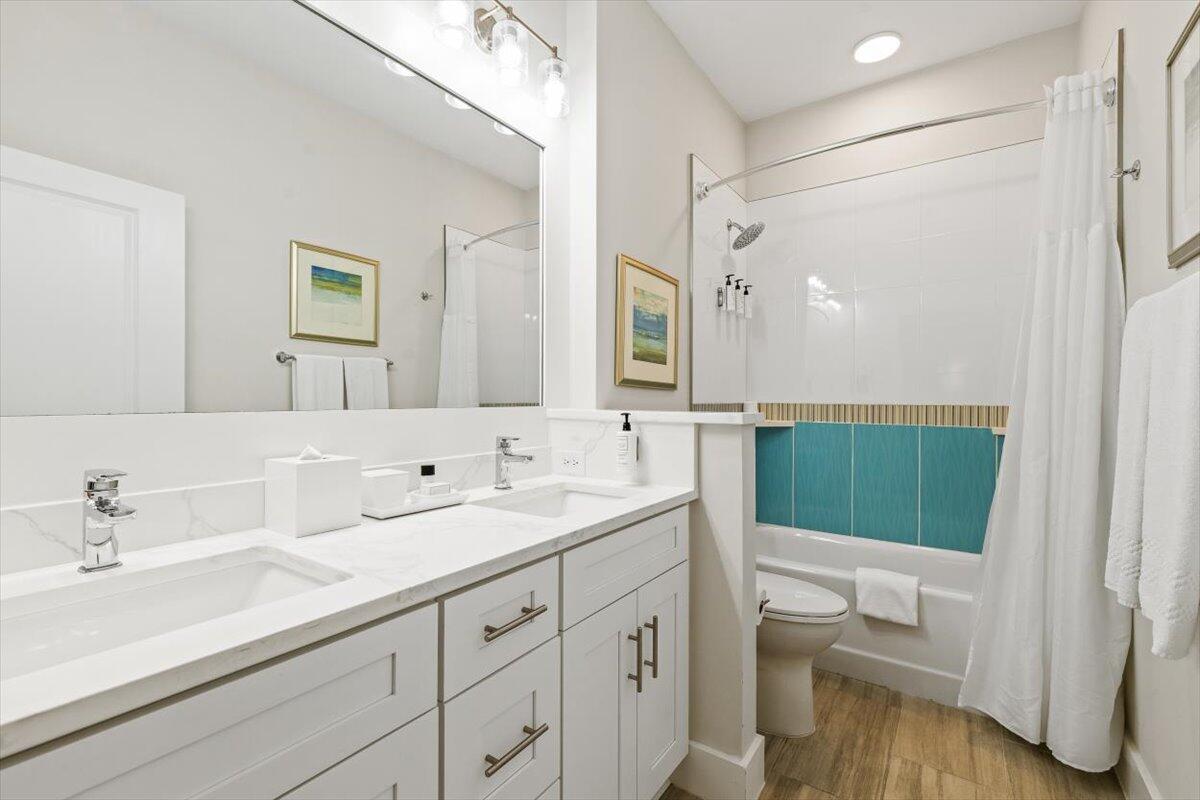206 Henderson Resort Way, Unit 5403 Destin, FL 32541 - Photo 25 of 41 a bathroom with a sink a toilet and a mirror