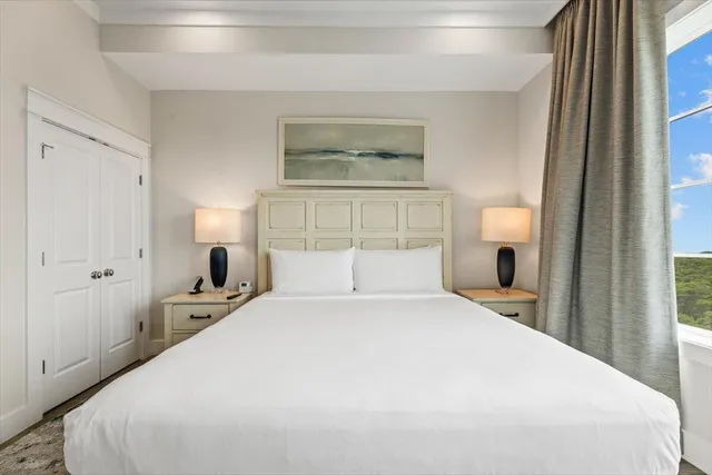 a bedroom with a large bed and a large window