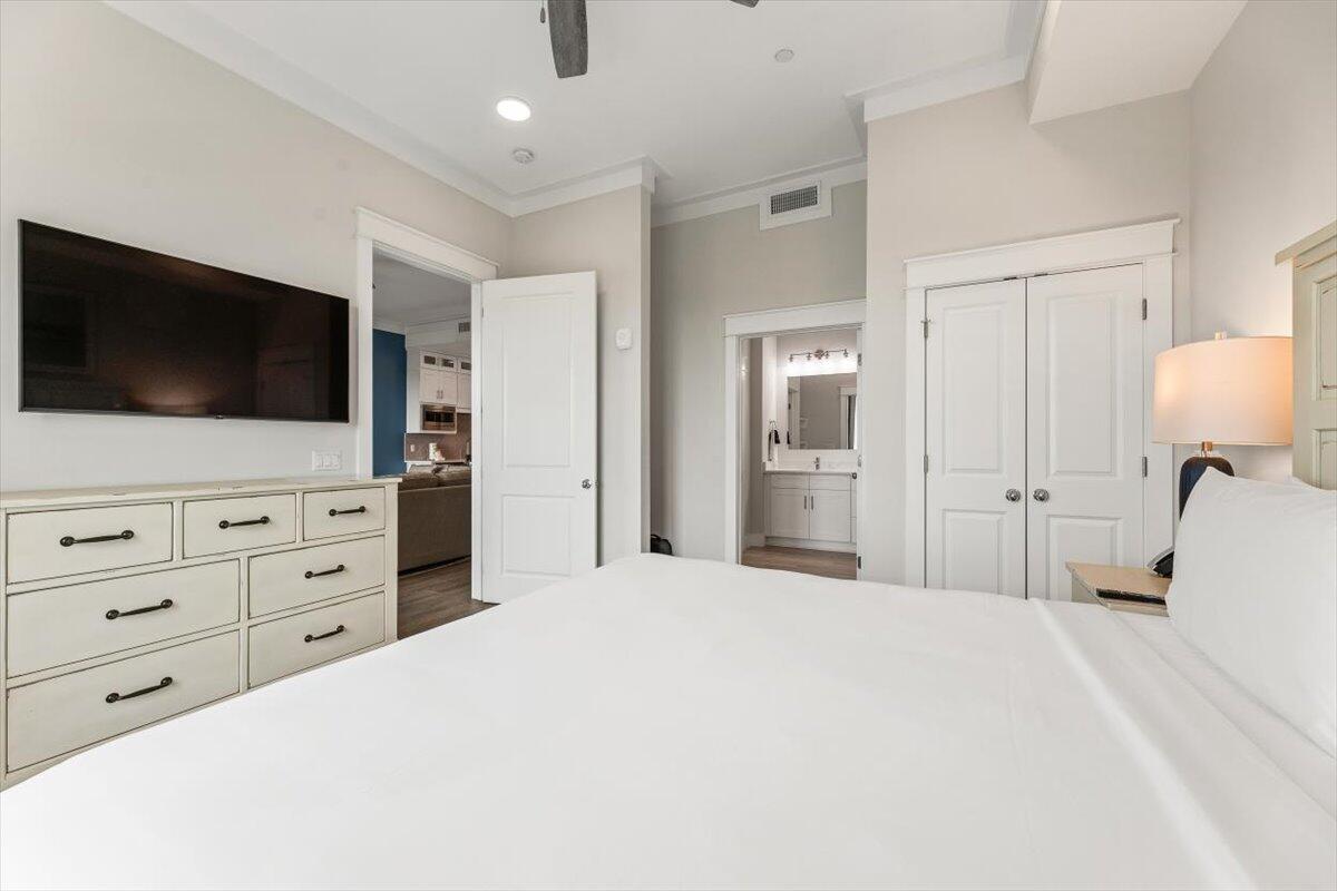 206 Henderson Resort Way, Unit 5403 Destin, FL 32541 - Photo 27 of 41 a large bedroom with a bed and flat screen tv