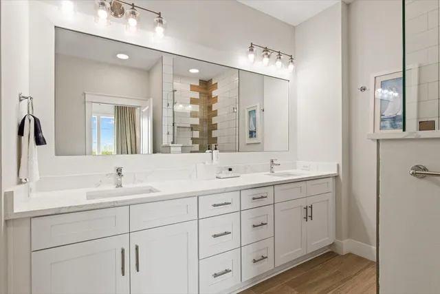 a bathroom with double vanity sinks and a mirror
