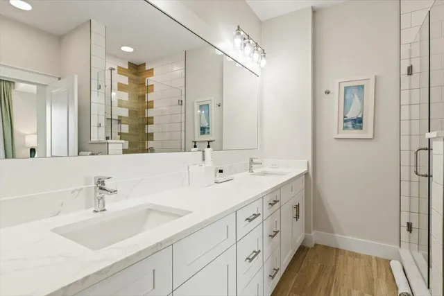 a bathroom with a double vanity sink and a mirror