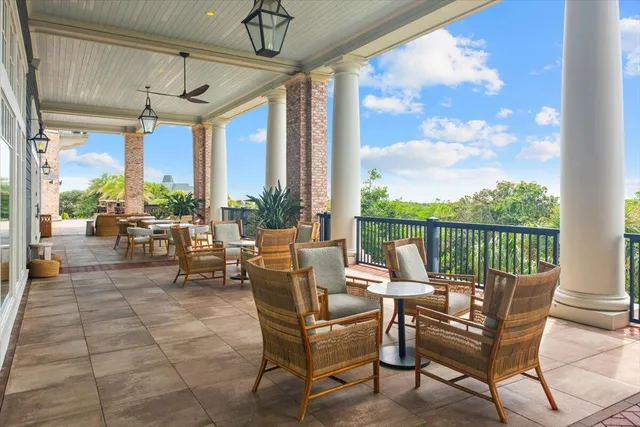 a view of a patio with a table and chairs and potted plants
