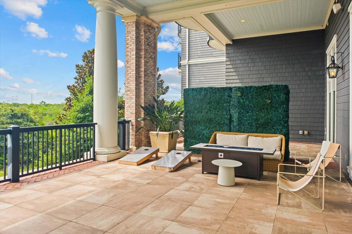 206 Henderson Resort Way, Unit 5403 Destin, FL 32541 - Photo 37 of 41 a view of a patio with a table and chairs and potted plants