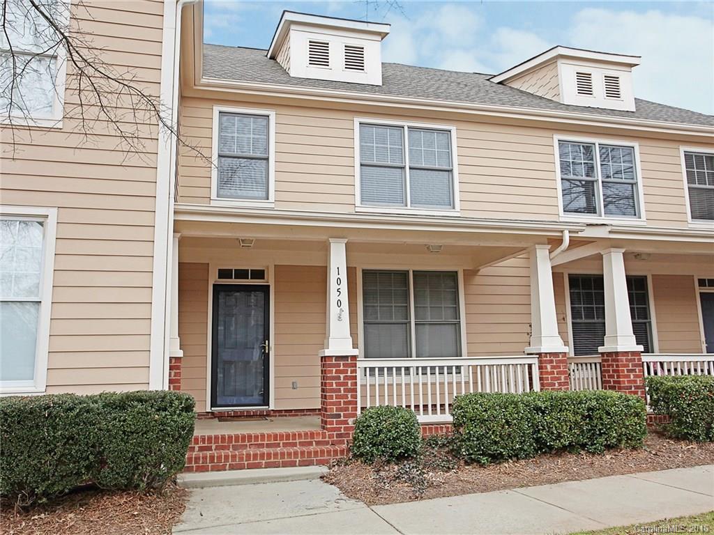 1050 Market Street, Unit 1050 Fort Mill, SC 29708 - Photo 1 of 20 a view of a brick house with many windows