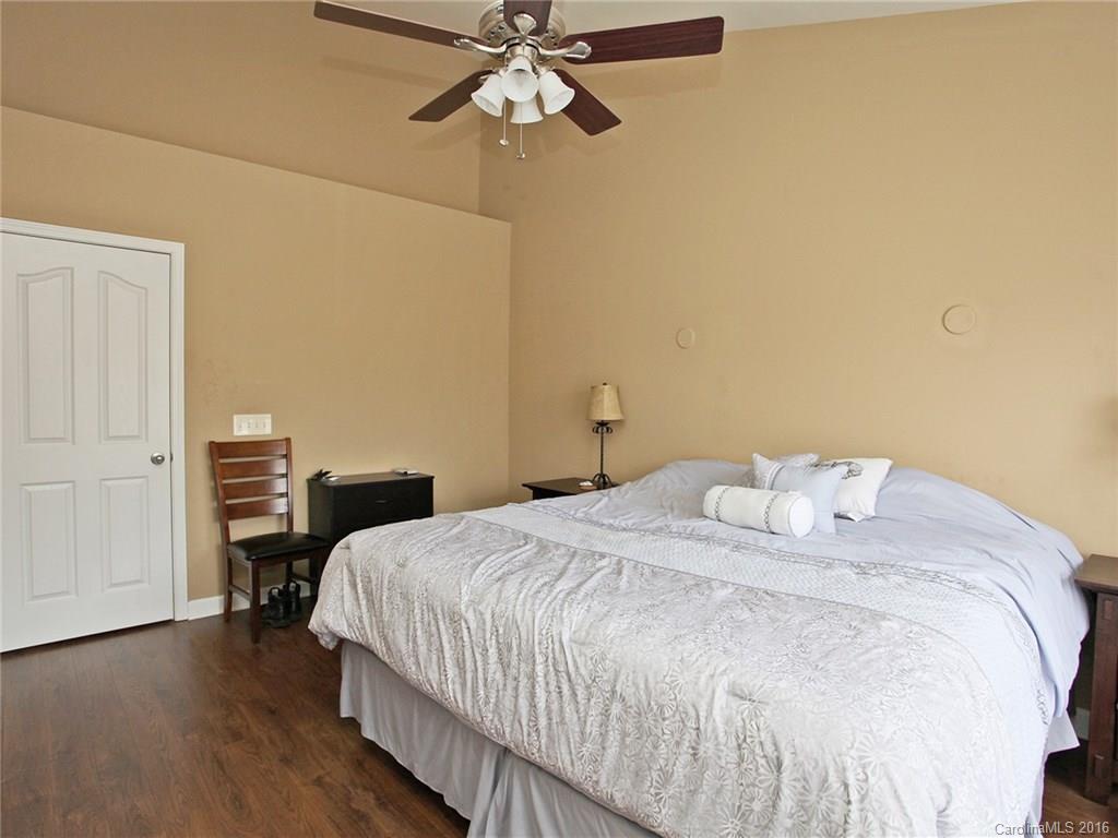1050 Market Street, Unit 1050 Fort Mill, SC 29708 - Photo 14 of 20 a bedroom with a bed and wooden floor