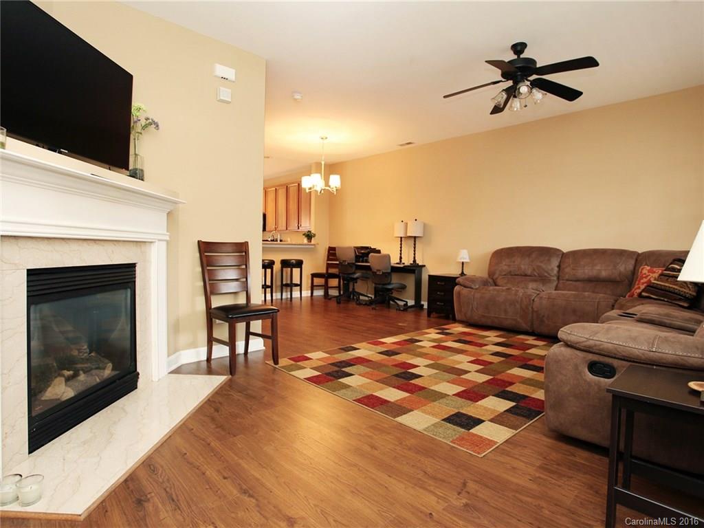 1050 Market Street, Unit 1050 Fort Mill, SC 29708 - Photo 3 of 20 a living room with furniture a fireplace and a flat screen tv