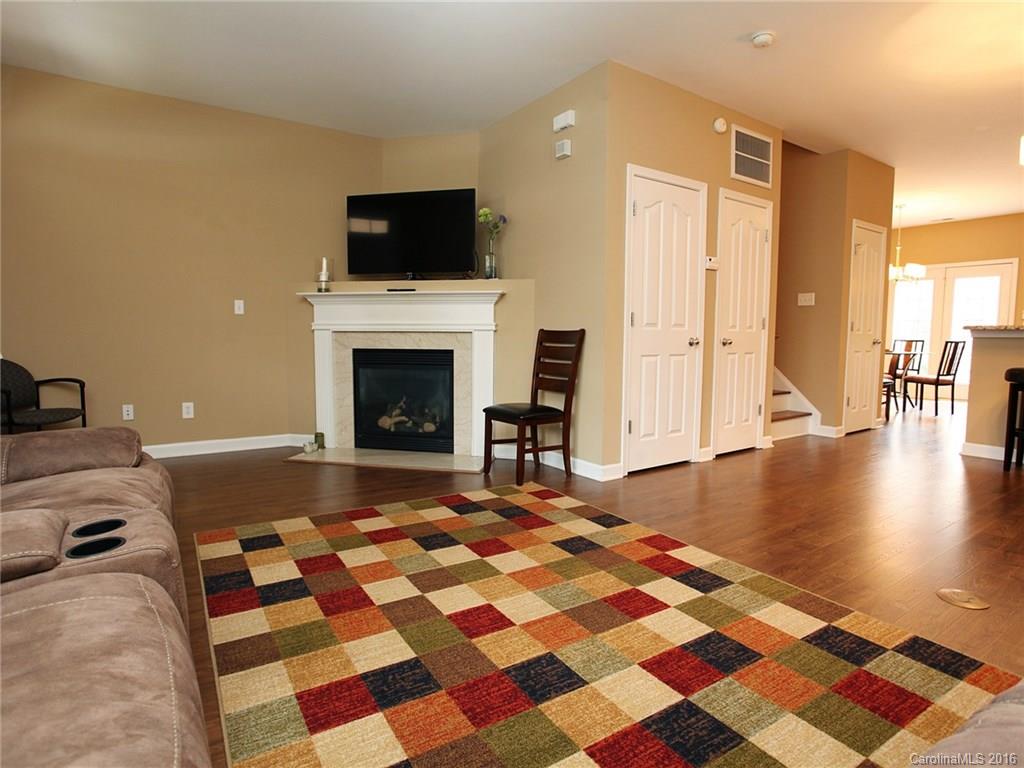 1050 Market Street, Unit 1050 Fort Mill, SC 29708 - Photo 4 of 20 a living room with a rug and a fireplace