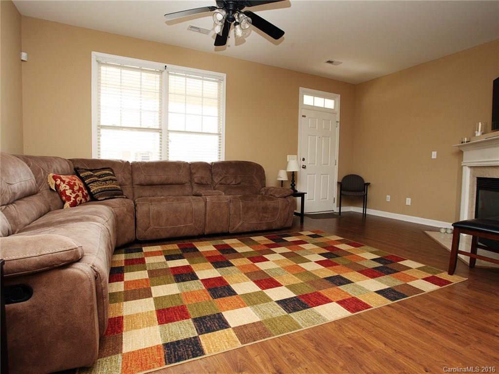 1050 Market Street, Unit 1050 Fort Mill, SC 29708 - Photo 5 of 20 a living room with a couch and a dining table