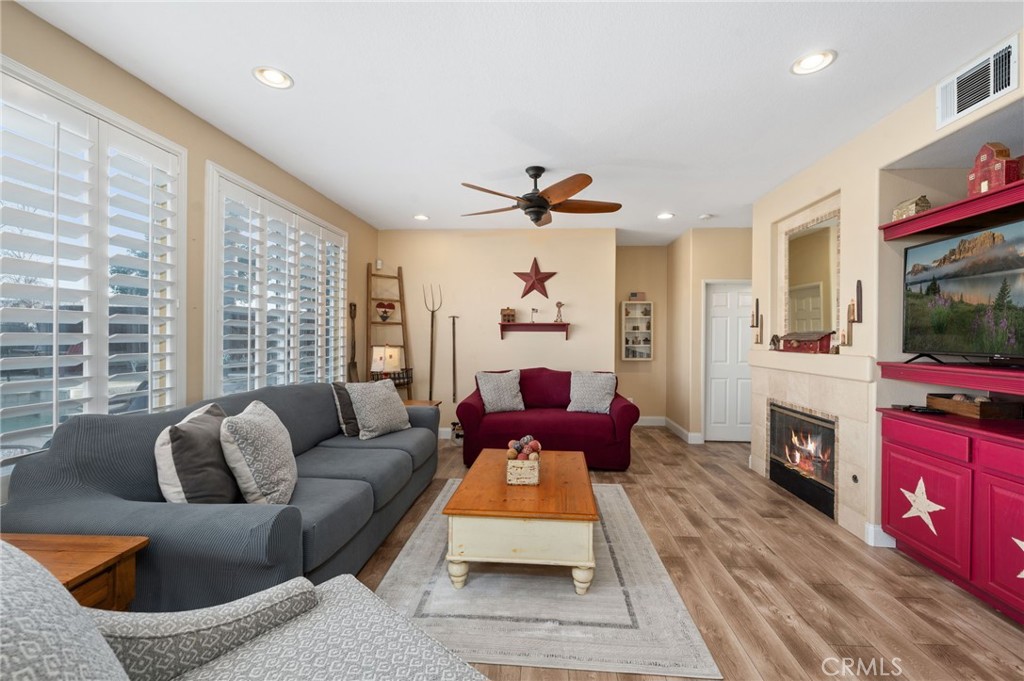 19714 Rotterdam Street Riverside, CA 92508 - Photo 12 of 46 a living room with furniture a flat screen tv and a fireplace