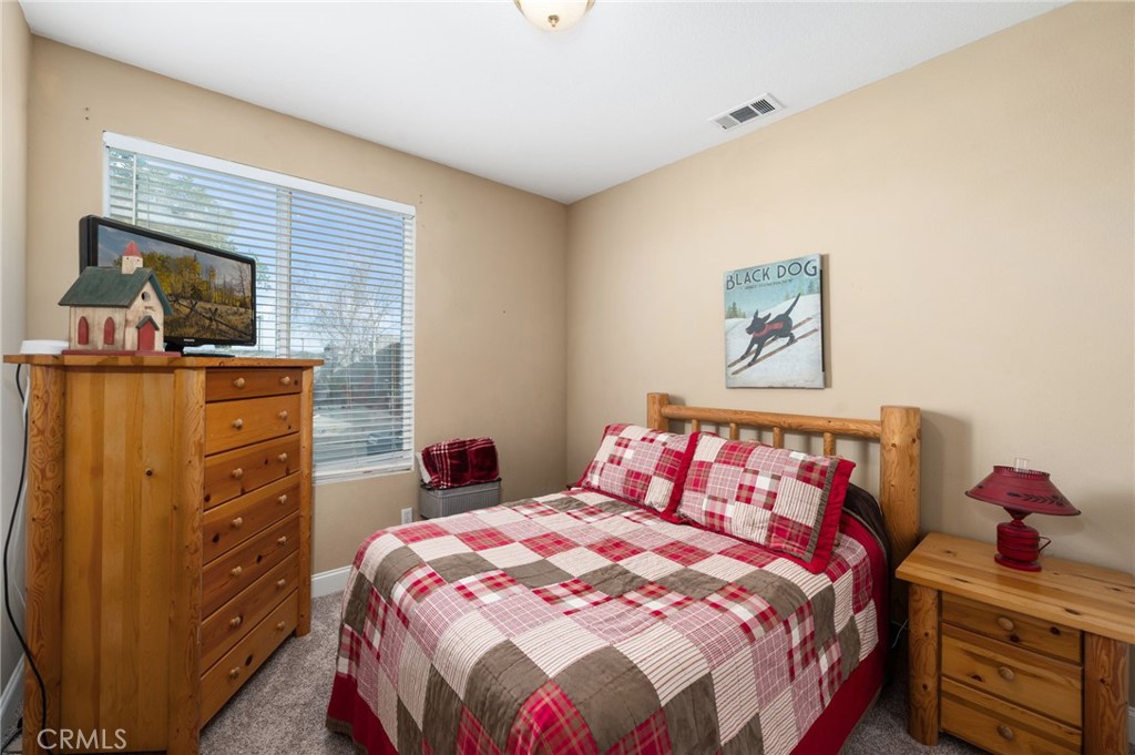 19714 Rotterdam Street Riverside, CA 92508 - Photo 19 of 46 a bedroom with a bed and furniture