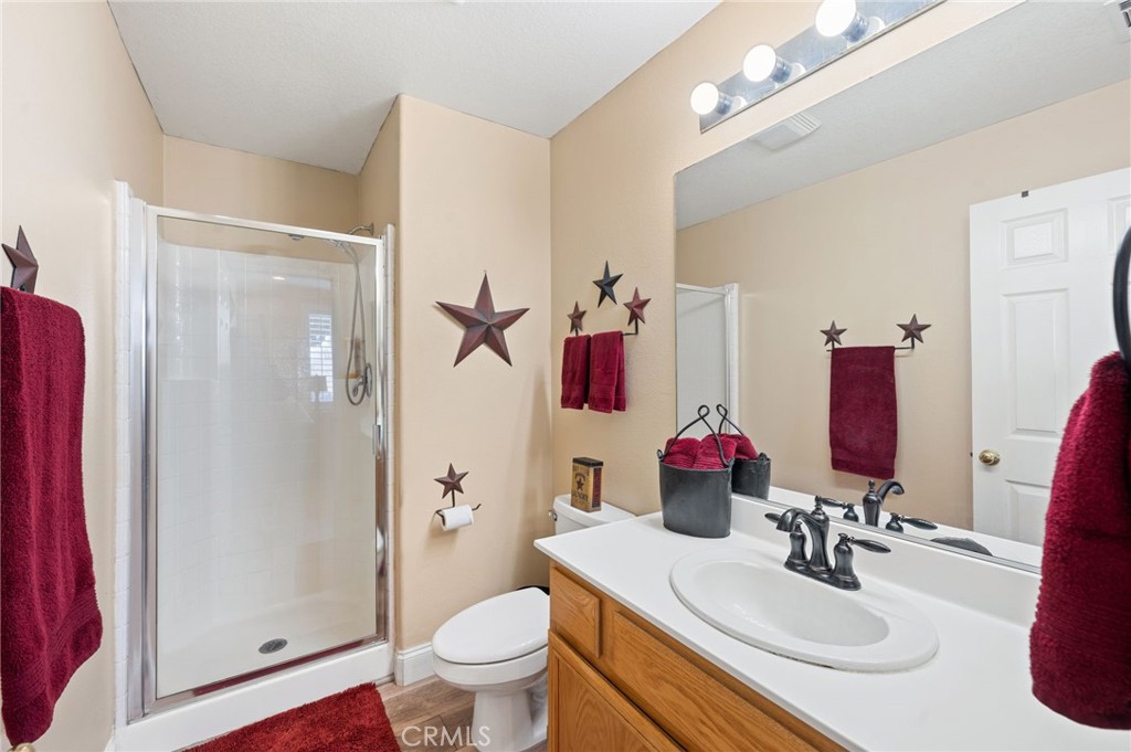 19714 Rotterdam Street Riverside, CA 92508 - Photo 20 of 46 a bathroom with a sink vanity mirror and toilet