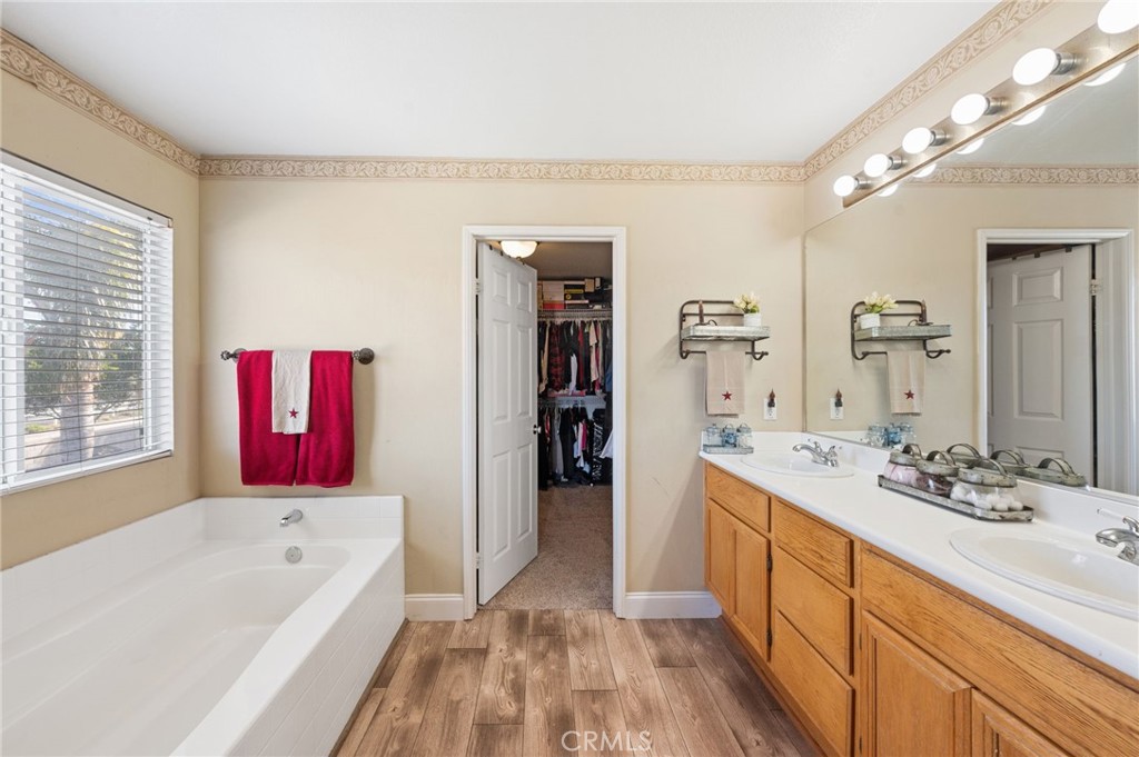 19714 Rotterdam Street Riverside, CA 92508 - Photo 25 of 46 a bathroom with a tub sink and mirror