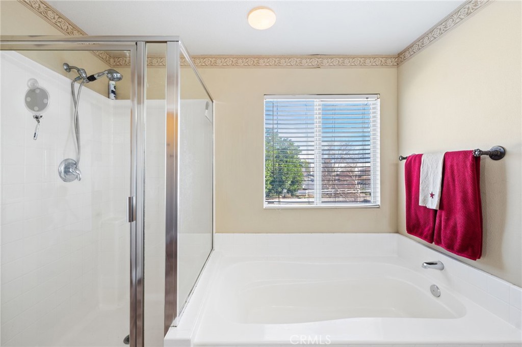 19714 Rotterdam Street Riverside, CA 92508 - Photo 26 of 46 a bathroom with a bathtub and shower