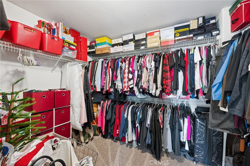 19714 Rotterdam Street Riverside, CA 92508 - Photo 27 of 46 a view of walk in closet with clothes