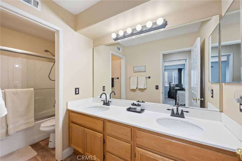 19714 Rotterdam Street Riverside, CA 92508 - Photo 29 of 46 a bathroom with a double vanity sink mirror and toilet