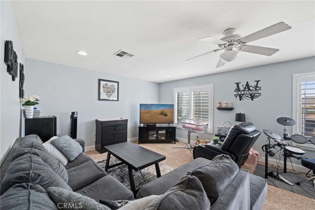 19714 Rotterdam Street Riverside, CA 92508 - Photo 30 of 46 a living room with furniture and a fireplace