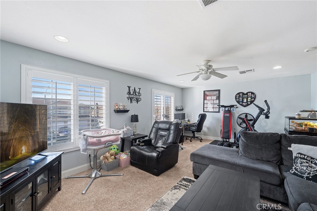 19714 Rotterdam Street Riverside, CA 92508 - Photo 33 of 46 a living room with furniture and a flat screen tv