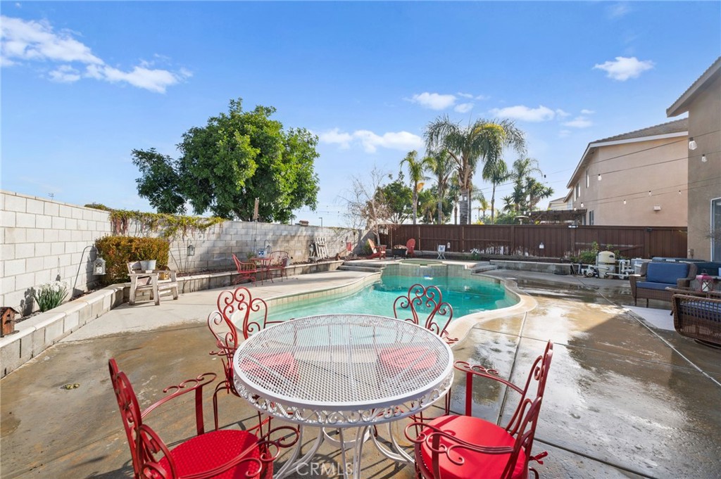 19714 Rotterdam Street Riverside, CA 92508 - Photo 36 of 46 a swimming pool with outdoor seating and yard