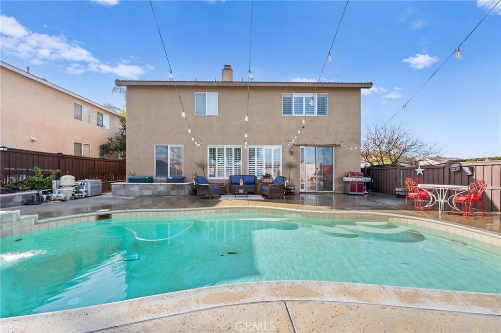 19714 Rotterdam Street Riverside, CA 92508 - Photo 39 of 46 a front view of a house with a yard table and chairs