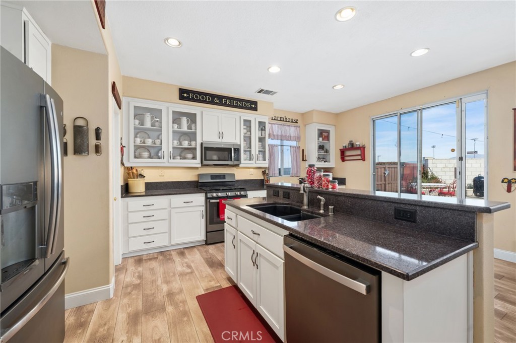 19714 Rotterdam Street Riverside, CA 92508 - Photo 9 of 46 a kitchen with a sink stove and refrigerator